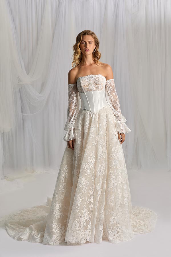 Junge Frau mit locker gewelltem Haar trägt ein cremefarbenes Spitzenkleid mit Korsett