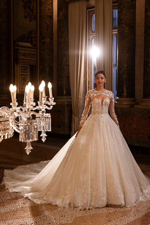 Eine elegant gekleidete Frau im Glitzerhochzeitskleid steht stolz im prunkvollen Saal